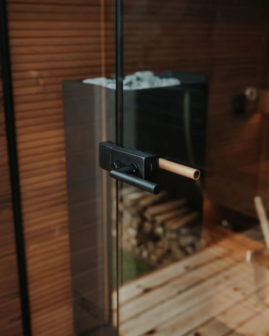 Close-up of a sauna's glass door and fittings